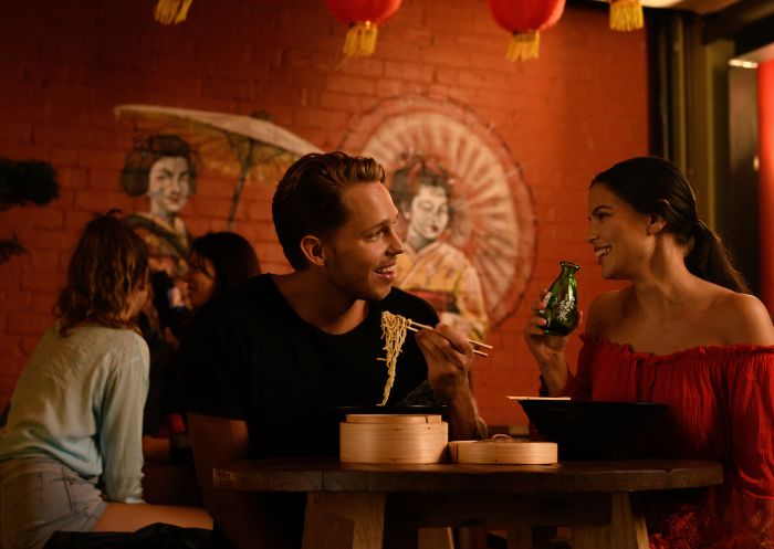 Couple enjoying food and drink at Spice Alley - Chippendale