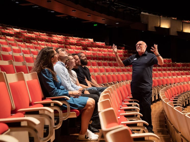 Tour guide with tour patrons inside Joan Sutherland Theatre