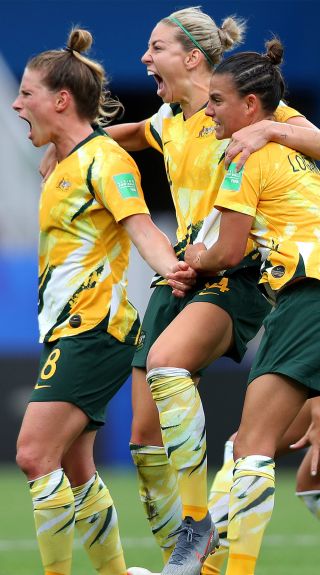 Australia players celebrate after their team's third goal - Credit: Naomi Baker - FIFA/FIFA via Getty Images